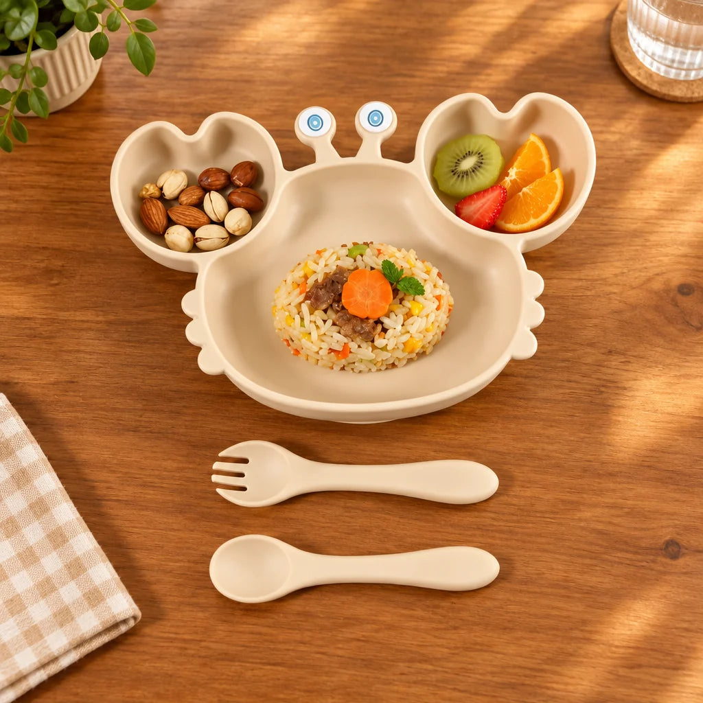 Children's plate with compartments filled with food, a fork, and a spoon on a beige background