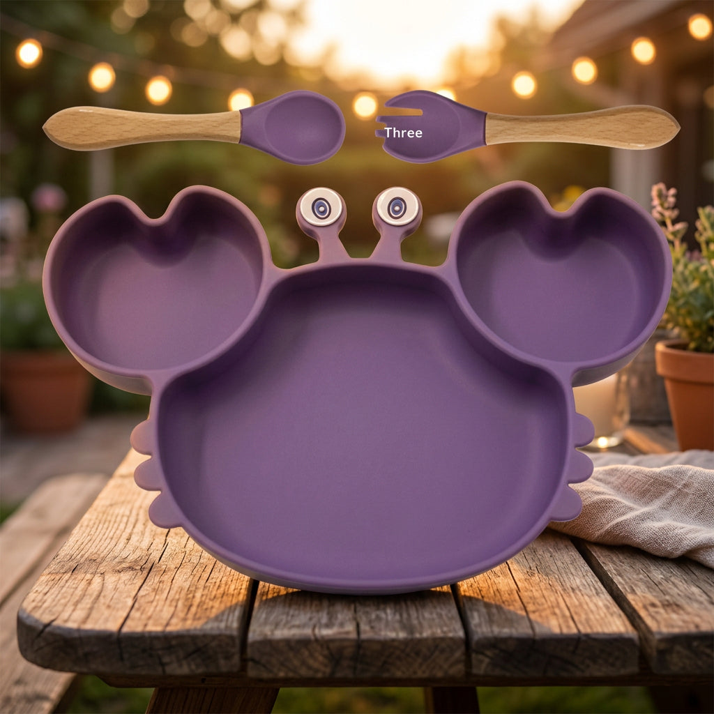 Purple children's plate with divided sections, a spoon, and a fork on a white background.