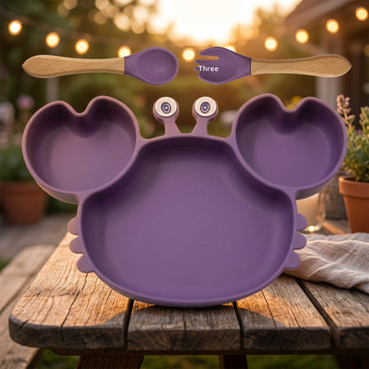 Purple children's plate with divided sections, a spoon, and a fork on a white background.