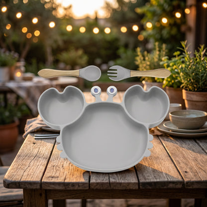 Children's plate with animal design, spoon, and fork on a white background